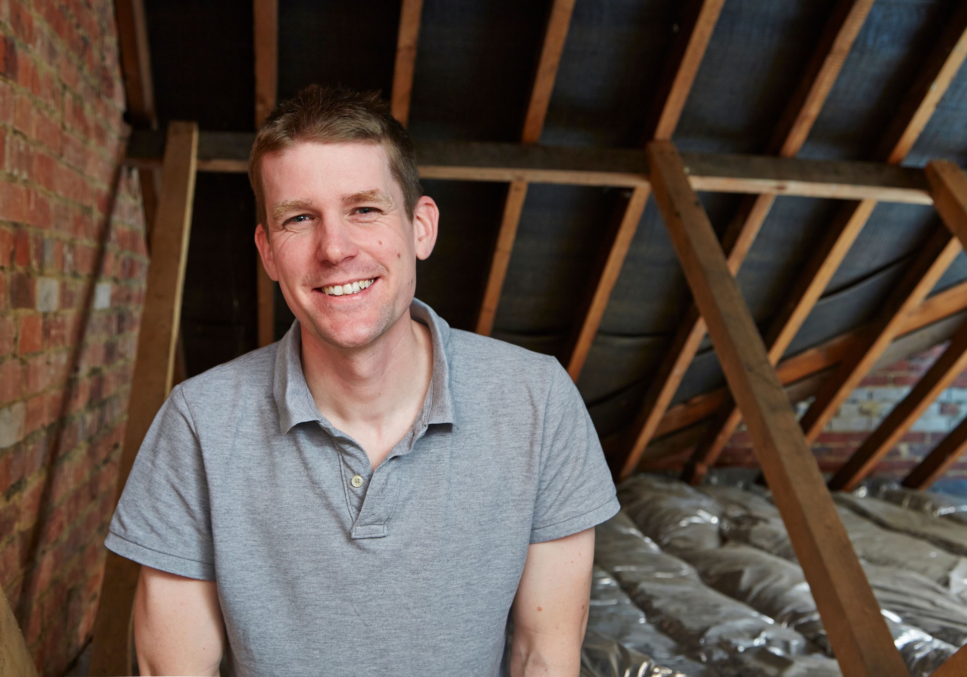 Tradesman portrait in attic on construction site